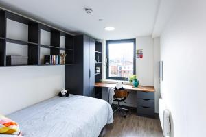 a bedroom with a bed and a desk and a window at New Era Living - Private Rooms next to Bramall Lane in Sheffield