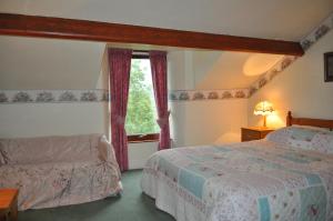 a bedroom with two beds and a window at Forest How Guest House in Eskdale +14 photos