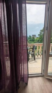 a sliding glass door with a view of a patio at Khatia's Guest House in K'obulet'i