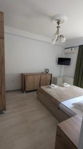 a bedroom with a bed and a ceiling fan at Khatia's Guest House in K'obulet'i