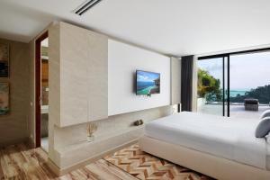 a bedroom with a large bed and a large window at Icon Villa Samui in Nathon Bay