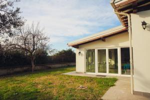 a house with a large sliding glass door at Guest House Montestallone in Formello +8 photos