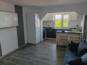a kitchen with a couch and a table in a room at Dani-Mihaela in Jurilovca