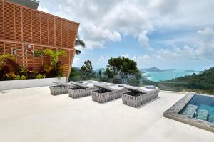 an outdoor patio with a view of the ocean at Icon Villa Samui in Nathon Bay