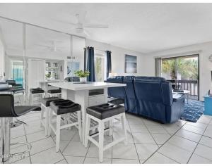 a kitchen and living room with a table and chairs at St Augustine Beach Condo in Saint Augustine