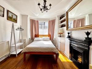 a bedroom with a bed and a fireplace at The OX1 in Oxford +5 photos