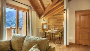 a living room with a couch and a table at Zarabella Delle Alpi in Temù