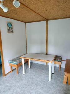 a ping pong table and benches in a room at 13 vents in Castanet +5 photos