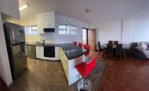 a kitchen and living room with a table and a couch at Unit 102 Warnadoone in Kingsburgh