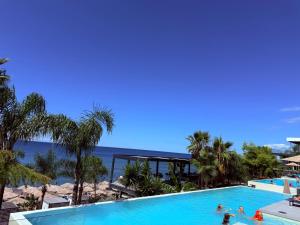 a pool at a resort with people in it at Rana Hedhun Seaside 1 in Lezhë