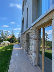 an external view of a building with sliding glass doors at Casa da Marola in Zas