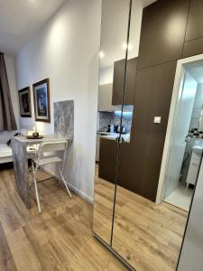 a kitchen with a desk and a table in a room at Apartmány v srdci Ružinova in Trnávka