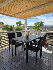 a wooden deck with a table and chairs on it at Stone Haven Mobile Home - Senj in Volarice