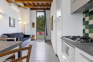 a kitchen and living room with a stove at Agriturismo I Cipressi in Pontassieve +39 photos