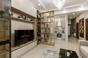 a living room with a television and a couch at Renest Vienna Moodspace in Chişinău +59 photos