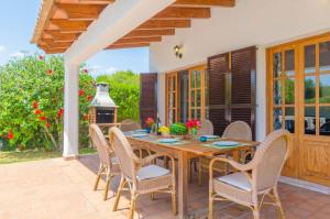 a table and chairs on a patio with a fireplace at Ca Na Martina in Cala d´Or