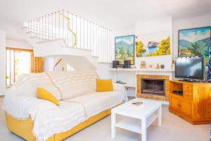 a bedroom with a bed and a tv and stairs at Ca Na Martina in Cala d´Or