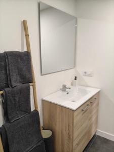 a bathroom with a sink and a mirror at Casa de Pedra in Melide