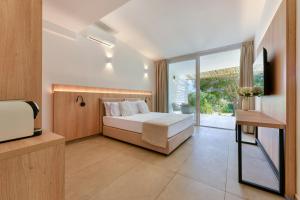 a bedroom with a bed and a sliding glass door at Cala Lupo Resort in Stintino