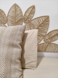 a bed with a pillow next to a plant at Casa de Pedra in Melide