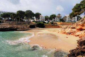 a view of a beach with buildings in the background at Ca Na Martina in Cala d´Or
