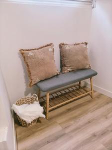 a bench in a corner with two pillows on it at Casa de Pedra in Melide +19 photos