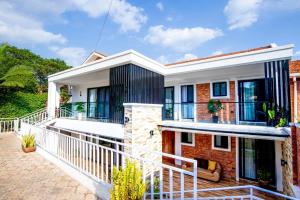 an exterior view of a house with a balcony at Chic, comfortable house for Rent with Honore Rwanda in Kigali