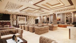 a large room with couches and a stage at Solace Suites Hotel & Banquets in Barog
