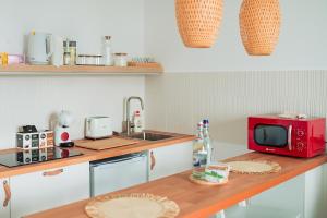 a kitchen with a red microwave on a wooden counter at Garsoniera Rin Grand in Bucharest