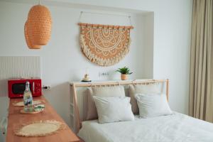 a bedroom with a bed with white sheets and a table at Garsoniera Rin Grand in Bucharest