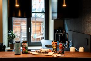 a table with a sandwich and three soda cans at Koderle Suite K2 Arnica in Brunico