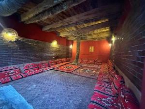 a room with a bunch of red chairs and a brick wall at New star hotel in Siwa +36 photos
