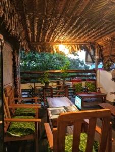 a restaurant with wooden tables and chairs and a window at Amazon Home-Feliz Puerta in Iquitos