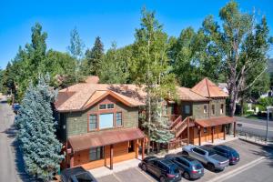 an aerial view of a house with cars parked in a parking lot at Aspen Hideaway by AvantStay Walk to Aspen Near Slopes Pool Hot Tub Access in Aspen