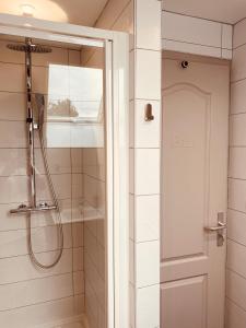 a shower with a glass door in a bathroom at La Maison de Pêcheur in Étaples