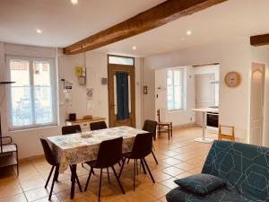 a kitchen and living room with a table and chairs at La Maison de Pêcheur in Étaples +7 photos