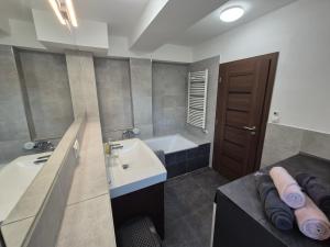 a bathroom with a sink and a bath tub at Apartman Centrum Mudronova in Košice +42 photos