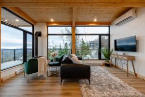 a living room with large windows and a couch at Ski Chalet with Sauna - Mountain - L'Elegant in Saint Come +44 photos