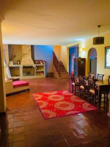 a living room with a table and chairs and a rug at Maya safari village in Arusha