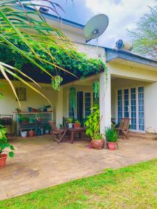 a house with a patio in front of it at Maya safari village in Arusha +13 photos