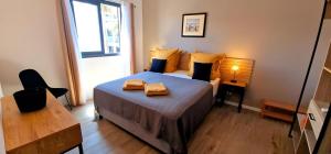 a bedroom with a bed with two towels on it at Villa cardinal in Saint-Pierre +16 photos