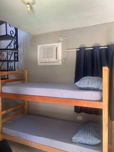 a bunk bed with a air conditioner on it at Hostel Casa Jambo Guaruja in Guarujá +128 photos
