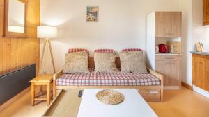 a living room with a couch and a table at Les Grizzlis N 20 - 2P6 in Saint-Sorlin-dʼArves