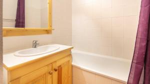 a bathroom with a sink and a bath tub at Les Grizzlis N 20 - 2P6 in Saint-Sorlin-dʼArves +36 photos