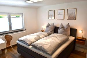 a bedroom with a large bed with pillows on it at Fuchsbau Voßwinkel in Arnsberg