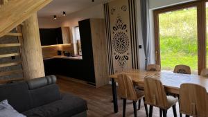 a kitchen and dining room with a table and chairs at Domek Góralski Reset in Gliczarów Górny