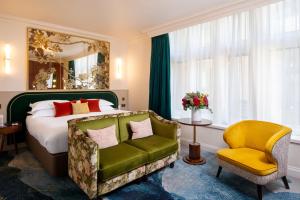a bedroom with a bed and a chair at The Capital Hotel, Apartments & Townhouse - Small Luxury Hotels of The World in London