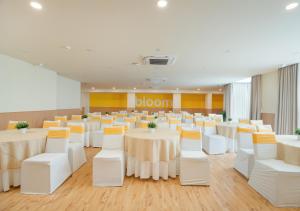 a banquet hall with white tables and white chairs at Bloom Boutique l Sector 45 Gurugram in Gurgaon