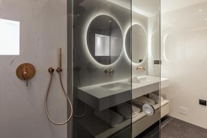 a bathroom with a sink and a mirror at The View at The Downtown Faro in Faro +29 photos