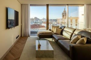 a living room with a couch and a large window at The View at The Downtown Faro in Faro